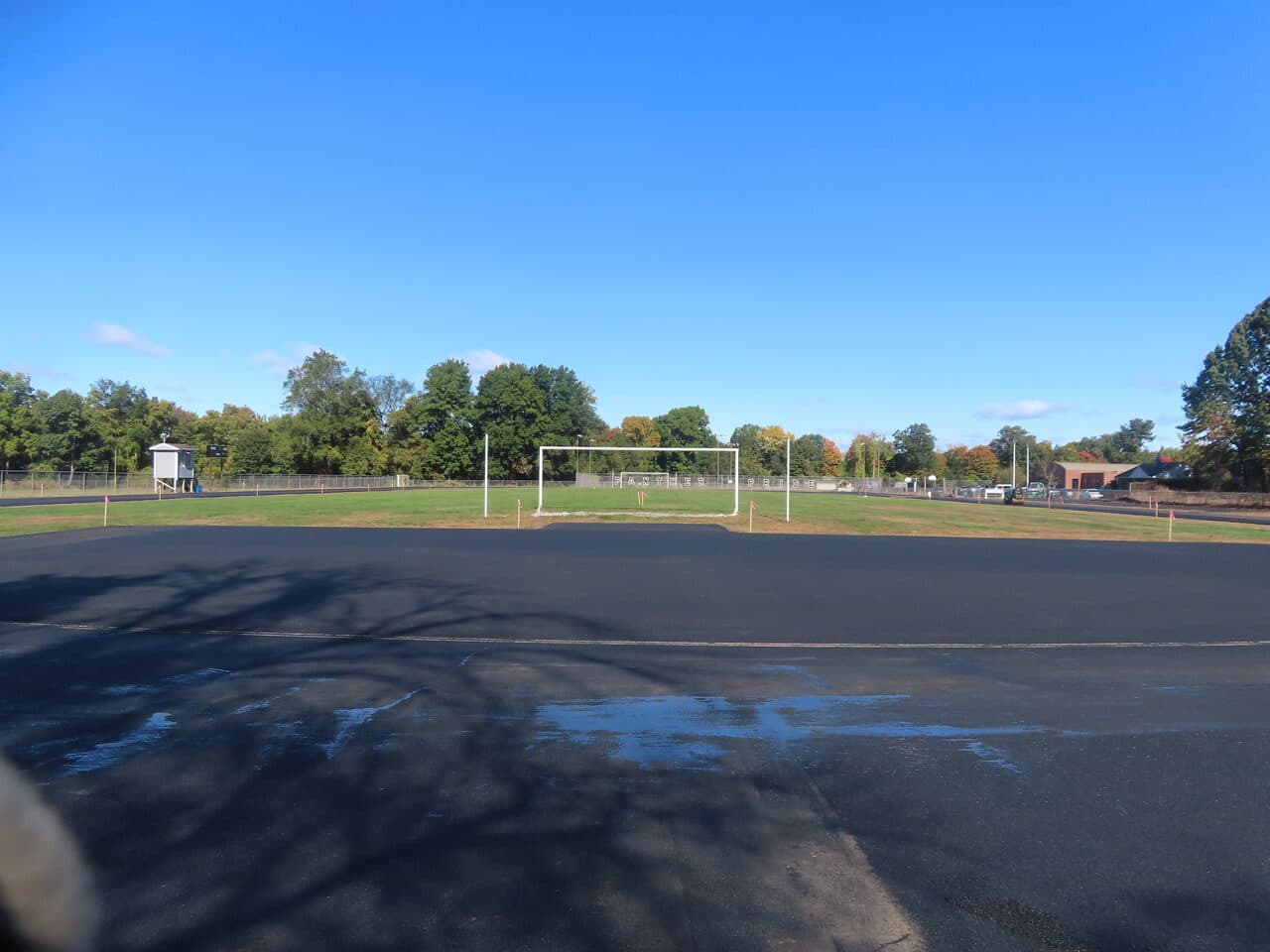 Finished asphalt running-track base around an athletic field